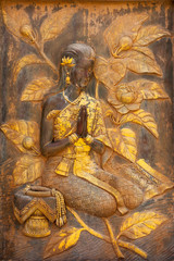 Wooden frame of a woman praying