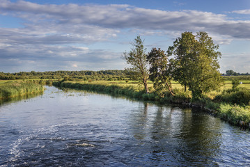 Fototapeta na wymiar River Biebrza next to Augustow Canal lock near Debowo village, Podlasie region of Poland