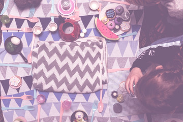 kids play make believe tea party with children's toys and tea set in bedroom