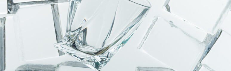 top view of transparent clear square ice cubes and empty glass on mirror, panoramic shot