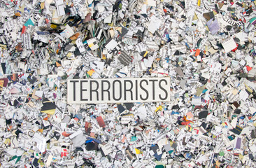 Newspaper confetti from above with the word TERRORISTS
