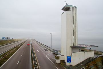 Traffic on the Afsluitdijk, a vast dike between the IJsselmeer en de Waddenzee in the Netherlands