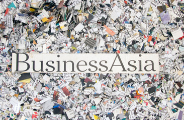 Newspaper confetti from above with the words Business Asia