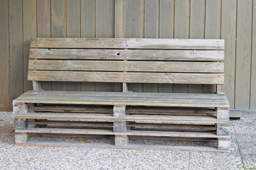 exterior bench made from old wooden storage pallet on home garden