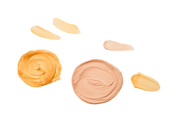Liquid body and face highlighter isolated on white background. Golden and beige color.