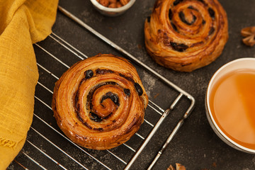 Fresh bun with raisins. Puff pastry snail bun. Traditional european pastries.