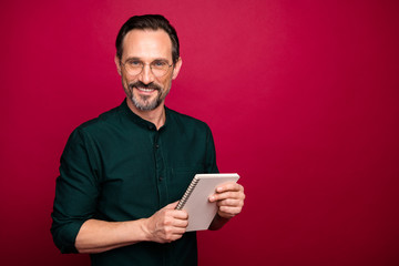 Photo of cheerful positive handsome attractive man holding copybook for writing down interesting information from you isolated vivid color background