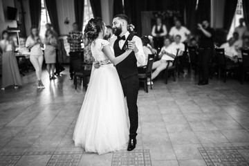 First wedding dance of newlywed. Happy bride and groom and their first dance in the elegant restaurant. Married couple having fun. Wedding day. Together. 