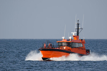 PILOT BOAT -  Orange auxiliary boat on the water