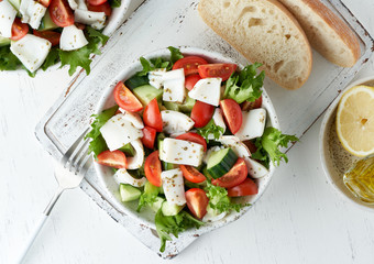 Salad with squid, cucumbers, tomatoes and lettuce. LCHF, FODMAP, paleo diet. Top view