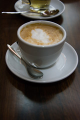 Chocolate milk coffee in white ceramic mug, breakfast
