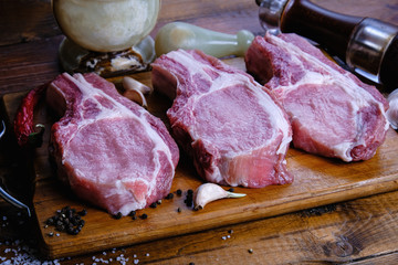 fresh raw pork loin with ribs on a wooden background