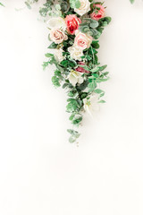 Flower pattern made of pink, beige roses flower buds on white background. Flat lay, top view.