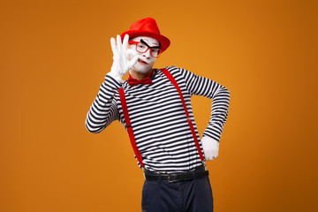 Mime man in vest and red hat Isolated on orange background