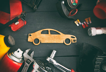 A lot of different car accessories and equipment on the wooden table