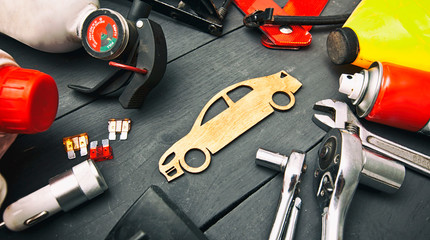 A lot of different car accessories and equipment on the wooden table