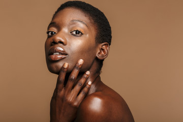 Beauty portrait of young half-naked african woman with short black hair