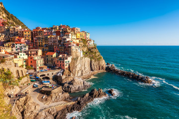 Fototapeta na wymiar Panoramic view of beautiful town of Manarola - one of five famous colorful villages of Cinque Terre National Park in Italy, Liguria region.