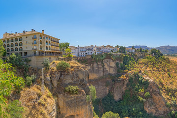 View of the city and the stone gorge - the channel of the Guadalevin River. Ronda, Spain, Andalusia.
