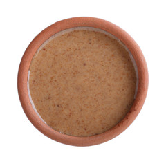 Apricot kernel butter smooth, urbech.  Natural paste from apricot kernels in bowl isolated on white. Top view.
