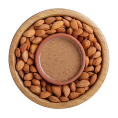 Apricot kernel butter smooth, urbech.  Natural paste from apricot kernels in wooden clay bowl isolated on white. Top view.