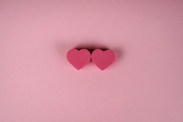 Two hearts on the pink background. Valentines day concept, loving hearts connected to each other. 