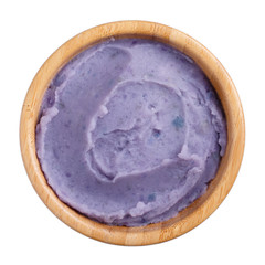 Mashed  purple potatoes in wooden bowl isolated on white background. Top view.