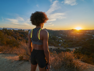 african american woman watching sunset while resting after hike at runyon canyon