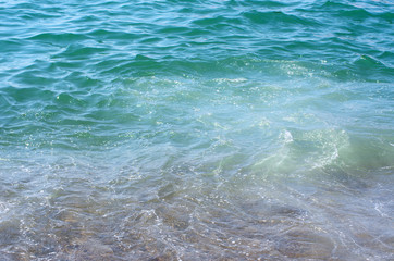 Fototapeta na wymiar Soft wave of sea on sandy beach. Background.