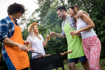 Friends having fun in nature doing bbq