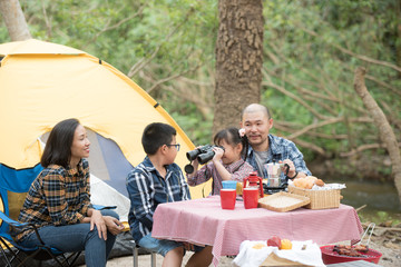 happy family has father and mother, brother and sister asian having fun to camping in river in summer time with smile and laughing healthy. summer camp for kids. vacation lifestyle concept.