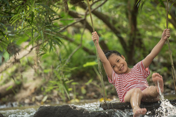 happy little asian girl and child having fun to playing in the river in summer time with smile and laughing healthy, smiling face adorable. Summer camp for kids. vacation lifestyle concept.