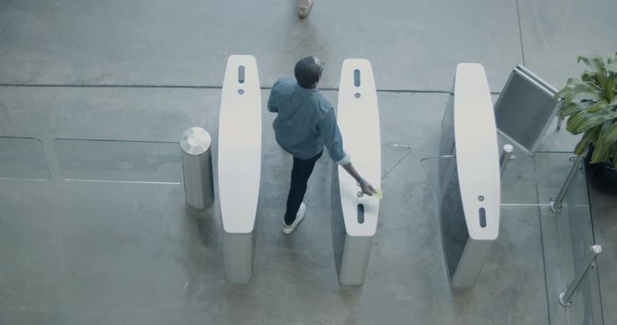 Overhead shot of security gates identifying people at entrance