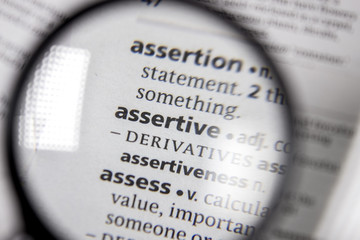 The word or phrase assertive in a dictionary.