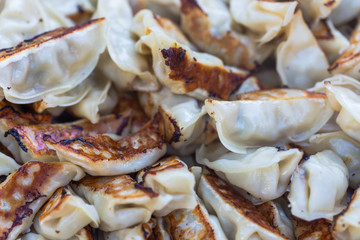 Pork and Cabbage Dumplings (Guotie or Jiaozi). Pile of gyoza. Gyoza Japanese style. Asian street food. Regional Food