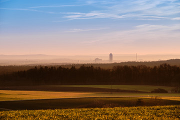 Beautiful rural sunset landscape with the skyline of Nuremberg in the background. Seen in Bavaria, Germany in January from Tauchersreuth.
