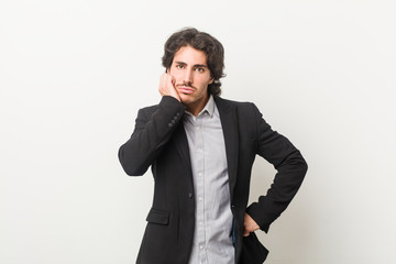 Young business man against a white background who is bored, fatigued and need a relax day.