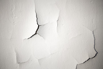 Cracks on a white plastered wall