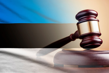 Lawyers wooden gavel over the flag of Estonia