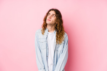 Long hair man posing isolated dreaming of achieving goals and purposes