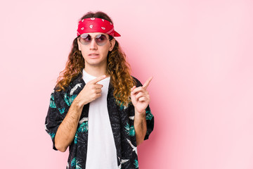 Young hippie caucasian man isolated shocked pointing with index fingers to a copy space.