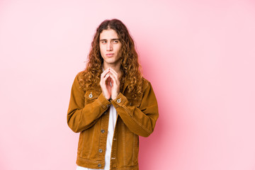 Young long hair man posing isolated making up plan in mind, setting up an idea.