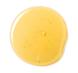 Honey drop isolated on white background, top view