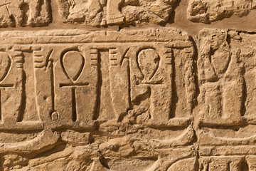 Karnak Temple, complex of Amun-Re. Embossed hieroglyphics on walls. Luxor Governorate, Egypt. Ankh...