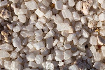 Quartz is a hard, crystalline mineral. White transparent pebbles, for decorating exteriors.