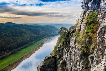 Fototapeta na wymiar View from the viewpoint from the Bastei bridge on the river Elba. Saxon Switzerland National Park in autumn