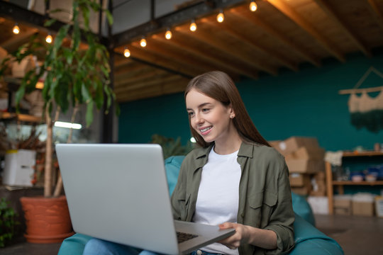 Smiling woman concentratedly working with her computer