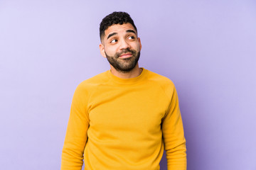 Young mixed race arabic man isolated dreaming of achieving goals and purposes