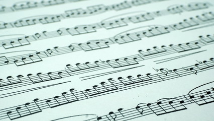  A sheet of paper with musical notes. Abstract background from musical notes for the designer.