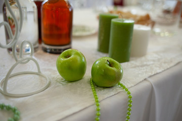 Beautiful green and white wedding decor of the bride and groom in a restaurant. Apple style in a restaurant. Apple decor